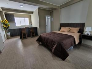 a bedroom with a bed and a table and chairs at Hotel Ayacucho in San Antonio