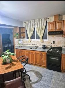 a kitchen with a table and a stove top oven at Casa Lola María in Mendoza