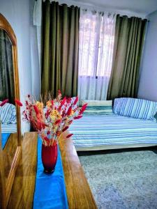 a room with a couch and a vase of flowers on a table at Casa Lola María in Mendoza