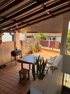 a patio with a table and a grill at Villa Morra House l in Asunción