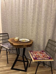 a table and two chairs with a plate on it at Montis Resort in Yeghegis
