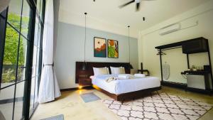 a bedroom with a bed and a large window at Humble Ella in Ella