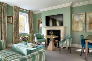 a living room with a couch and a table at Knightsbridge Hotel, Firmdale Hotels in London