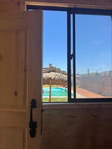 an open door with a view of a resort at Cabaña Camino al Valle in La Marquesa