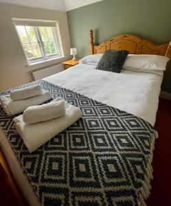a bedroom with a large bed with towels on it at Country inn in Staple