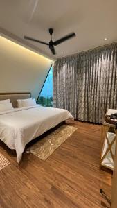 a bedroom with a bed and a large window at SkyGrove in Kodaikānāl