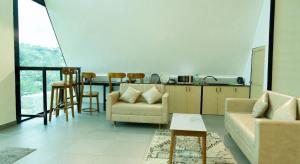 a living room with a couch and a table at SkyGrove in Kodaikānāl