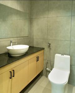 a bathroom with a white sink and a toilet at SkyGrove in Kodaikānāl +17 photos