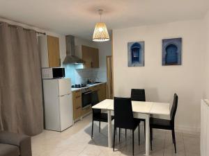a kitchen and dining room with a table and chairs at Gite de la Moulette in Bergerac