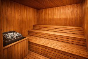 eine Holzsauna mit einem Tablett voller Steine darin in der Unterkunft Olimpija Hotel & SPA in Daugavpils