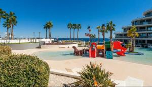 a playground at the beach with a slide at Infinity View apartment in Arenales del Sol