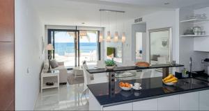 a kitchen and living room with a view of the ocean at Infinity View apartment in Arenales del Sol