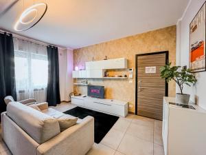 a living room with a couch and a tv at Velvet Suite - Garage Privato - Metro Dante in Turin