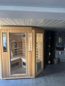 a wooden cabinet with a glass door in a room at Sisters spa room in Portet-sur-Garonne +7 photos