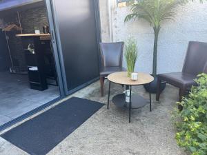 two chairs and a table in front of a door at Sisters spa room in Portet-sur-Garonne
