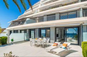 a house with a patio with a table and chairs at Infinity View apartment in Arenales del Sol