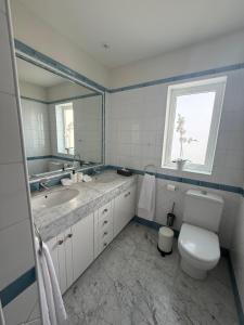 a bathroom with a toilet and a sink and a window at Mogán suite in Puerto de Mogán +8 photos