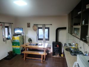 a kitchen with a wooden table and a stove at Milijin konak in Zaovine +11 photos