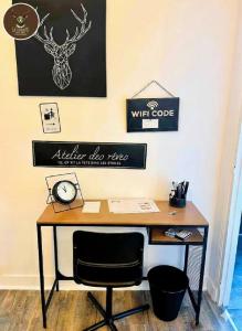 an office with a desk and a clock on a wall at La Cachette du Roi in Fontainebleau