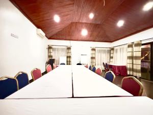 a conference room with a long table and chairs at Sienna Beach Hotel - Entebbe in Entebbe