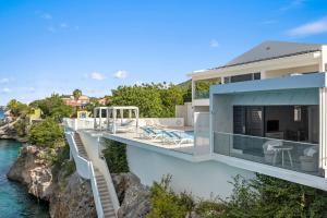 a house with a view of the water at Lagun Ocean View Apartments & Studio in Lagun