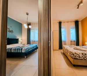 a view of a bedroom with two beds and a mirror at Velvet Suite - Garage Privato - Metro Dante in Turin +12 photos
