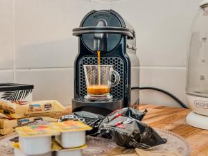 a black blender sitting on a table with food at Velvet Suite - Garage Privato - Metro Dante in Turin
