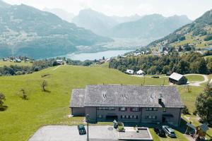 a house on a hill with a view of a valley at Schwendihaus in Amden