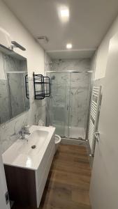 a white bathroom with a sink and a shower at La Divina Commedia in Florence