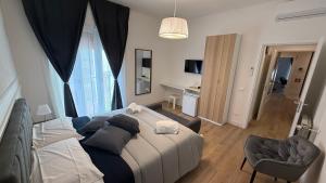 a bedroom with a bed and a chair in a room at La Divina Commedia in Florence