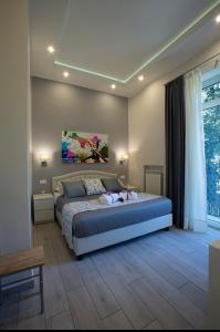 a bedroom with a bed and a large window at ROYAL GARDENS in Caserta