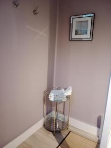 a stool in a room with a picture on the wall at Chambre d'hôtes au manoir proche mer in Gamaches +7 photos