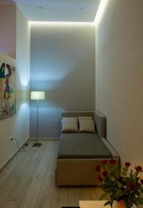a living room with a bed and a lamp in it at ROYAL GARDENS in Caserta