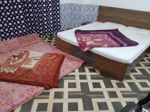 two beds sitting on the floor in a room at Classic hostel in Katra