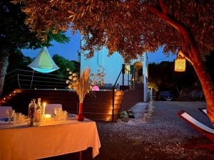 a table with candles on it in front of a house at Private villa Pyrgos - Heated Pool & Sea View - Walking distance from beaches & Liapades in Liapades