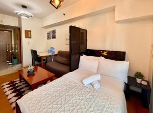 a bedroom with a bed and a living room at Cozy Condo in Ermita Manila near St Lukes Medical Center and US Embassy in Manila +7 photos