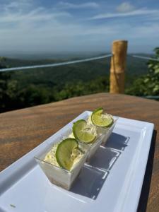a plate of food with lime slices on a table at Ecohotel La Reserva in Piojó