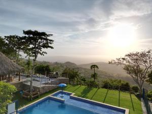 a resort pool with a view of the mountains at Ecohotel La Reserva in Piojó