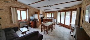 a living room with a couch and a table at Les Gites des Guézoux in Vaunac