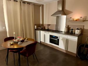 a kitchen with a table and chairs and a dining room at Maison avec Spa Privatif, Jacuzzi et Sauna in Bailleval