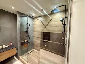 a shower with a glass door in a bathroom at Maison avec Spa Privatif, Jacuzzi et Sauna in Bailleval