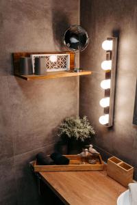 a bathroom with a shelf with a potted plant and a mirror at HOME AM SEE Ferienwohnung in Möhnesee +41 photos