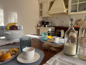 a kitchen with a table with a bottle of milk at Dimora dei Passi Lenti in Montegranaro