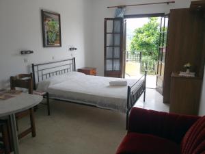 a bedroom with a bed and a sliding glass door at Villa Helen in Arillas