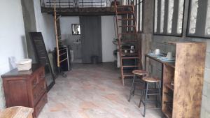 a room with a loft bed and a desk and stool at Alojamiento campestre in Cali