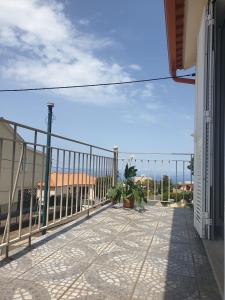 a balcony with a fence and a view of the ocean at Farol Golfe in Ponta do Pargo