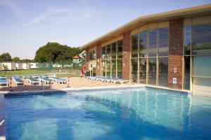 a swimming pool in front of a building at Caravan in Clacton-on-Sea in Little Clacton