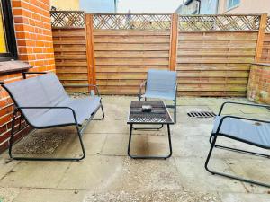 two chairs and a table on a patio at ODA Living Lüneburg in Lüneburg