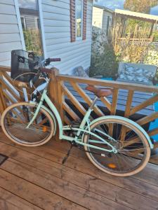a bike parked on a wooden fence on a porch at camping siblu le montourey fréjus in Fréjus