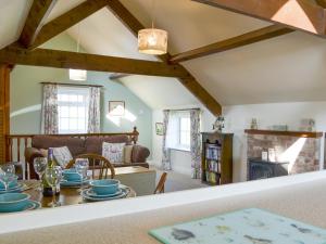 a living room with a table and a couch at Summertree Farm The Granary in Thornton Dale